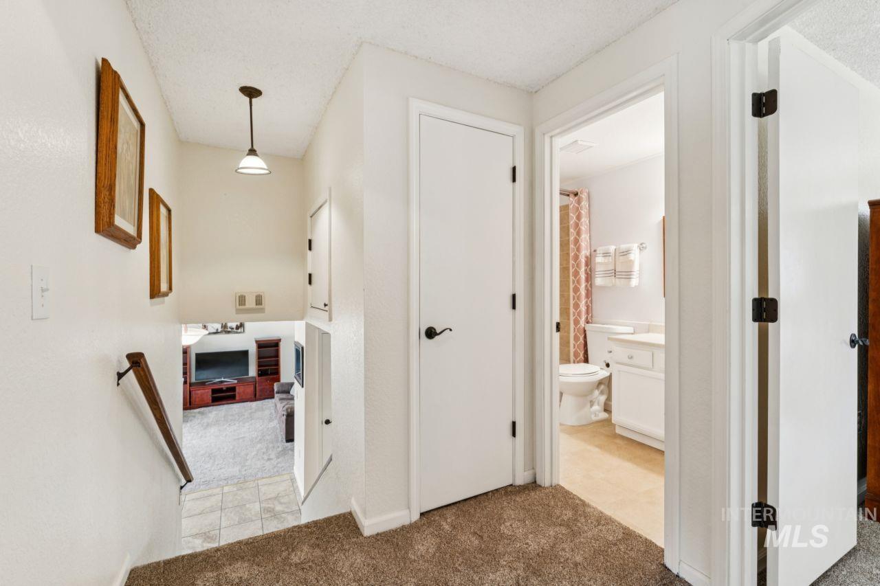 4093 North Marylebone Way Boise, ID 83713 - Photo 27 of 48 Hall featuring light colored carpet, a textured ceiling, and light tile patterned floors