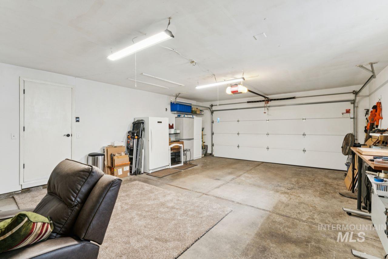 4093 North Marylebone Way Boise, ID 83713 - Photo 35 of 48 Garage with freestanding refrigerator and a garage door opener