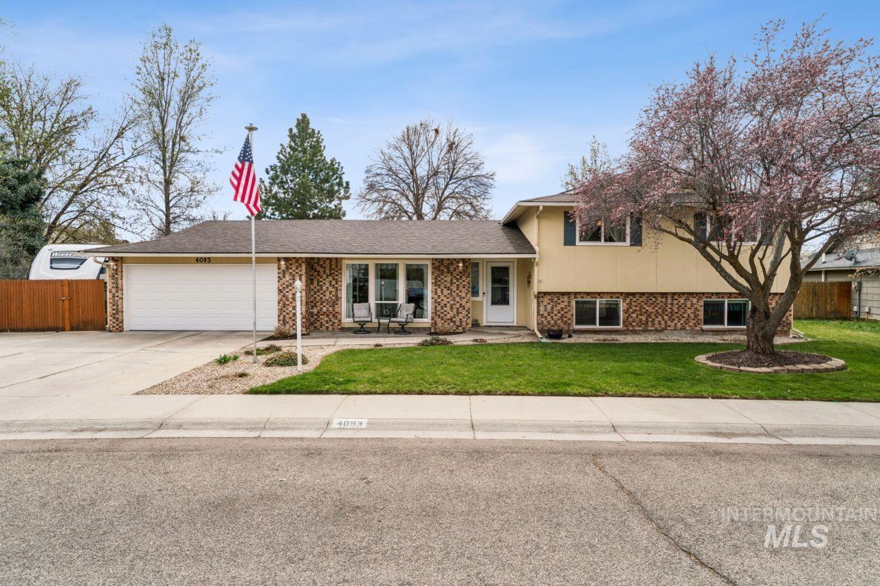 4093 North Marylebone Way Boise, ID 83713 - Photo 46 of 48 Tri-level home featuring brick siding, an attached garage, driveway, covered porch, and a shingled roof