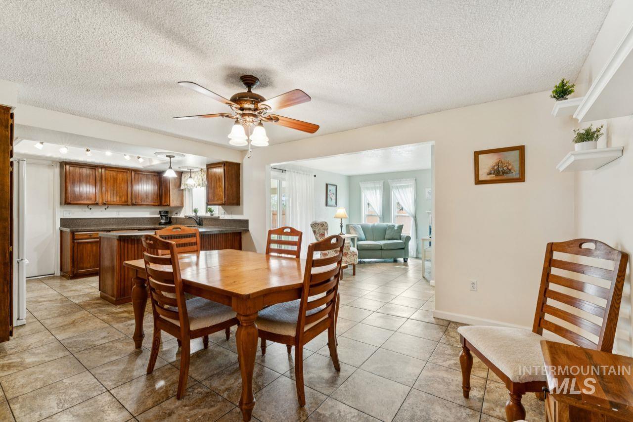 4093 North Marylebone Way Boise, ID 83713 - Photo 8 of 48 Dining space with a textured ceiling, ceiling fan, and light tile patterned floors