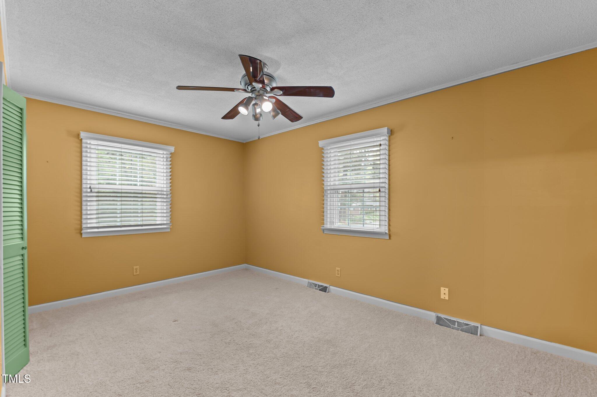 505 Forest Road Oxford, NC 27565 - Photo 13 of 31 a view of a big room with windows and chandelier fan