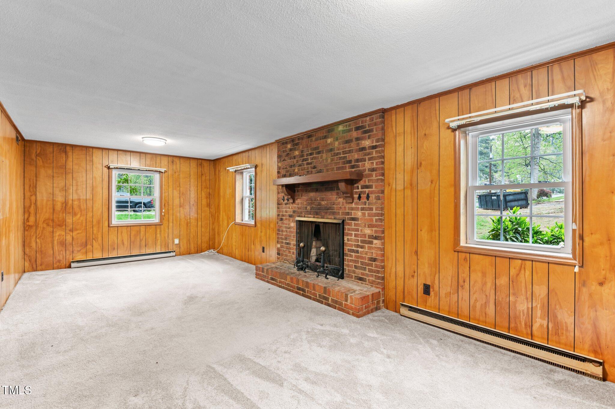 505 Forest Road Oxford, NC 27565 - Photo 16 of 31 an empty room with windows and fireplace