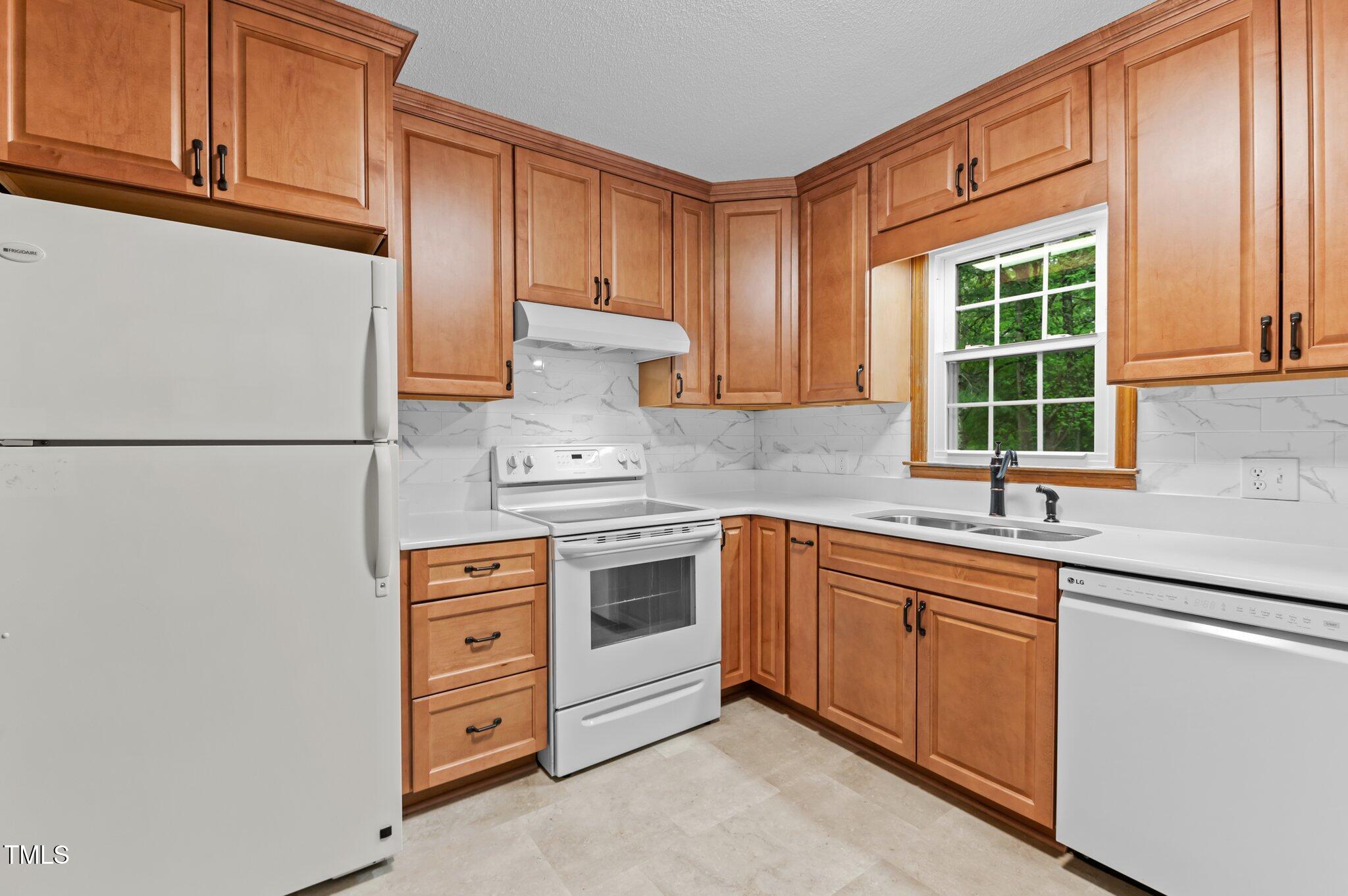 505 Forest Road Oxford, NC 27565 - Photo 8 of 31 a kitchen with stainless steel appliances granite countertop a sink and a stove next to a window