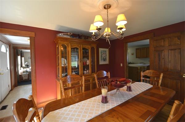 64 North Sturbridge Road Charlton, MA 01507 - Photo 13 of 30 a living room with furniture a chandelier and a large mirror