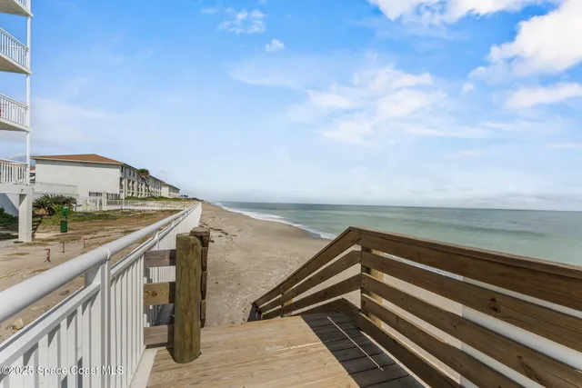 a kitchen with granite countertop a sink dishwasher stove and cabinets with wooden floor