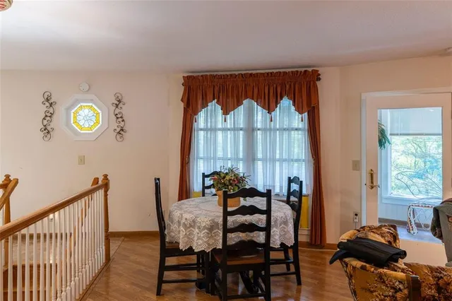 a view of a dining room with furniture and a window