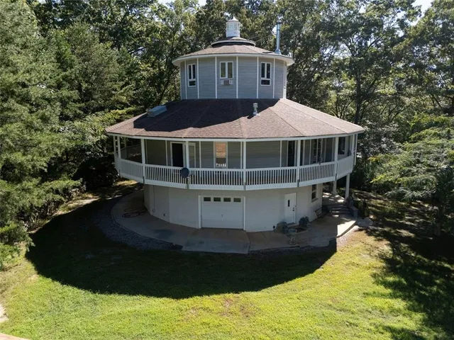 a view of a house with a yard and sitting area