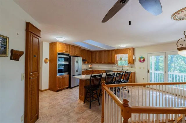 a view of a hallway with furniture and windows