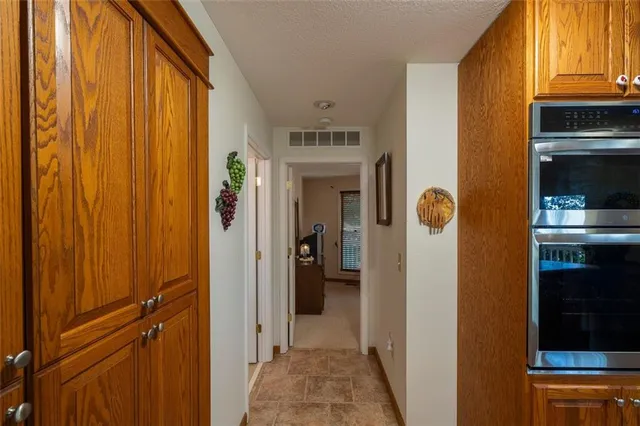 a view of a hallway with wooden shelves