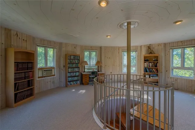 a view of a livingroom with furniture and staircase