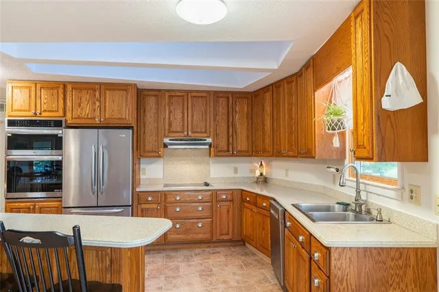 a kitchen with a sink a window and cabinets
