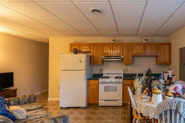 a kitchen with a refrigerator and a stove top oven