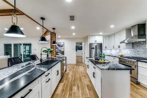 a kitchen with counter top space a sink stainless steel appliances and cabinets