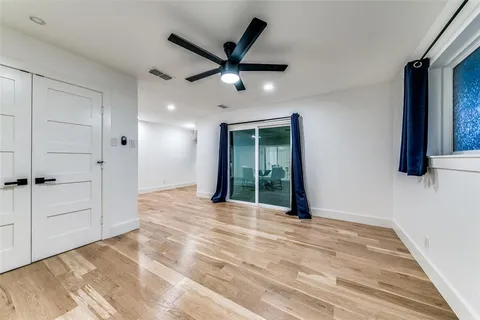 an empty room with closet and windows