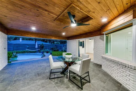 a view of a porch with furniture and a yard