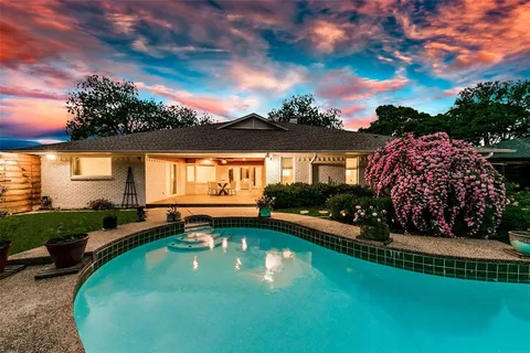 a view of a house with swimming pool and a yard