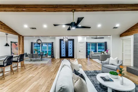 a living room with furniture a rug and a large window