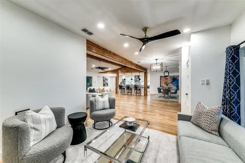 a living room with furniture and a view of dining room