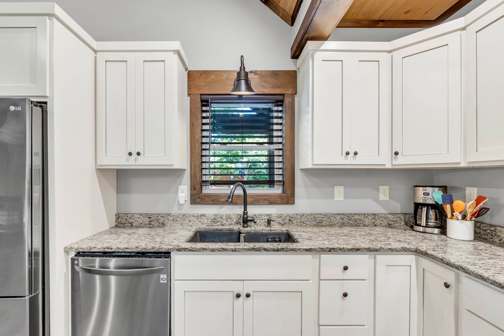 566 High Meadows Drive Morganton, GA 30560 - Photo 13 of 46 a kitchen with granite countertop a sink and a stove