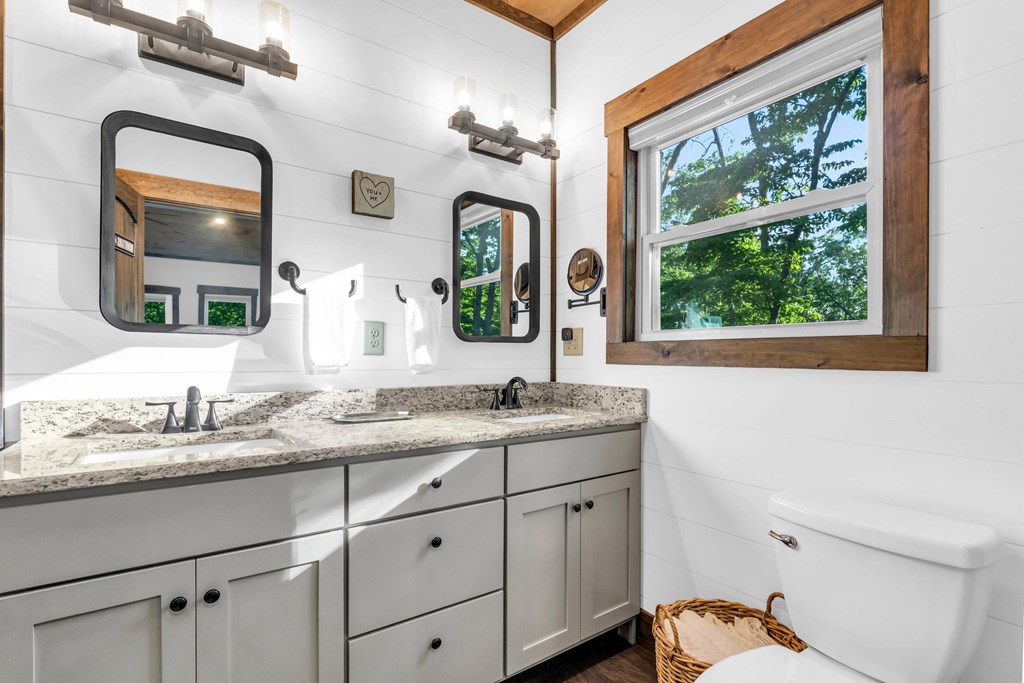 566 High Meadows Drive Morganton, GA 30560 - Photo 17 of 46 a bathroom with a granite countertop sink a large mirror a and a window