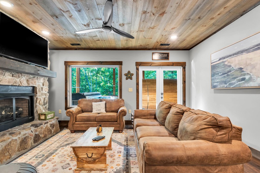 566 High Meadows Drive Morganton, GA 30560 - Photo 22 of 46 a living room with furniture a flat screen tv and a fireplace