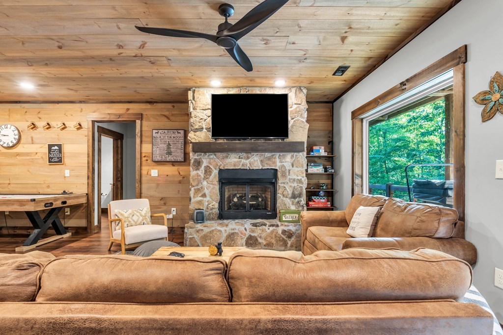 566 High Meadows Drive Morganton, GA 30560 - Photo 23 of 46 a living room with furniture a flat screen tv and a fireplace