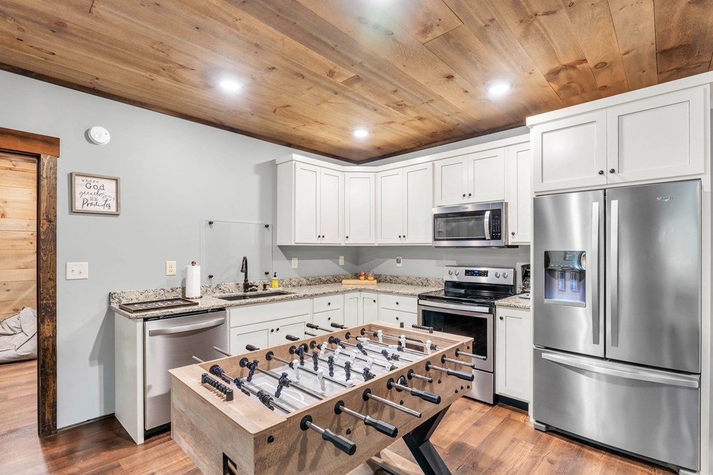 566 High Meadows Drive Morganton, GA 30560 - Photo 25 of 46 a kitchen with stainless steel appliances granite countertop a sink stove refrigerator and cabinets