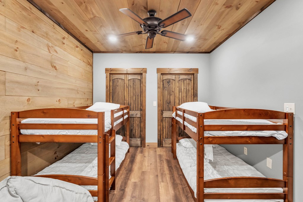 566 High Meadows Drive Morganton, GA 30560 - Photo 29 of 46 a bedroom with a bed and a chandelier