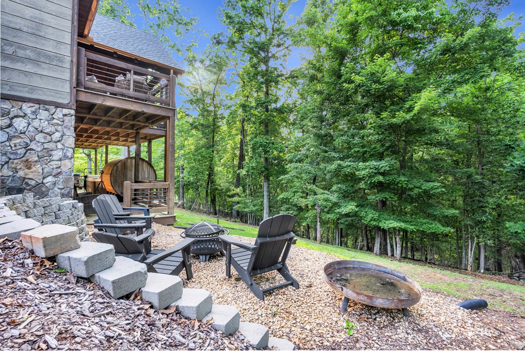 566 High Meadows Drive Morganton, GA 30560 - Photo 38 of 46 a view of a patio with couches table and chairs and potted plants