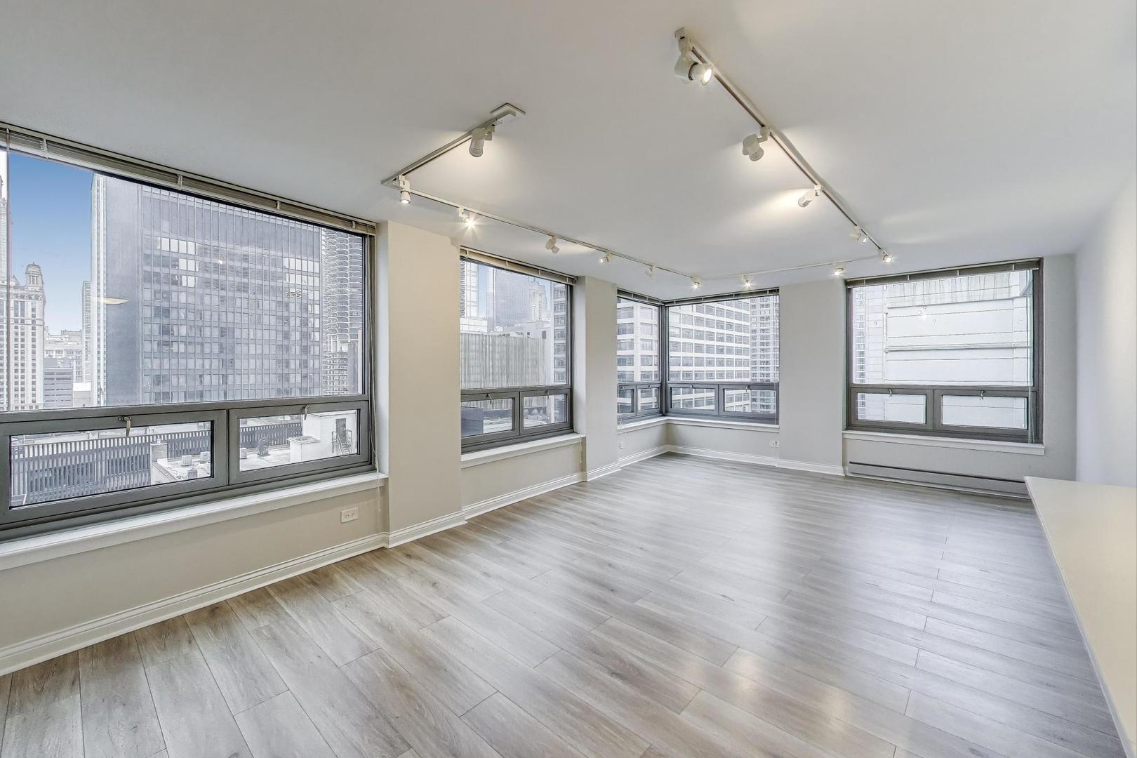 440 North Wabash Avenue, Unit 1605 Chicago, IL 60611 - Photo 12 of 53 a view of an empty room with a window and wooden floor