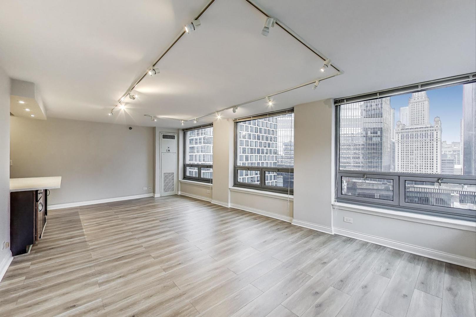 440 North Wabash Avenue, Unit 1605 Chicago, IL 60611 - Photo 16 of 53 a view of an empty room with a window and wooden floor
