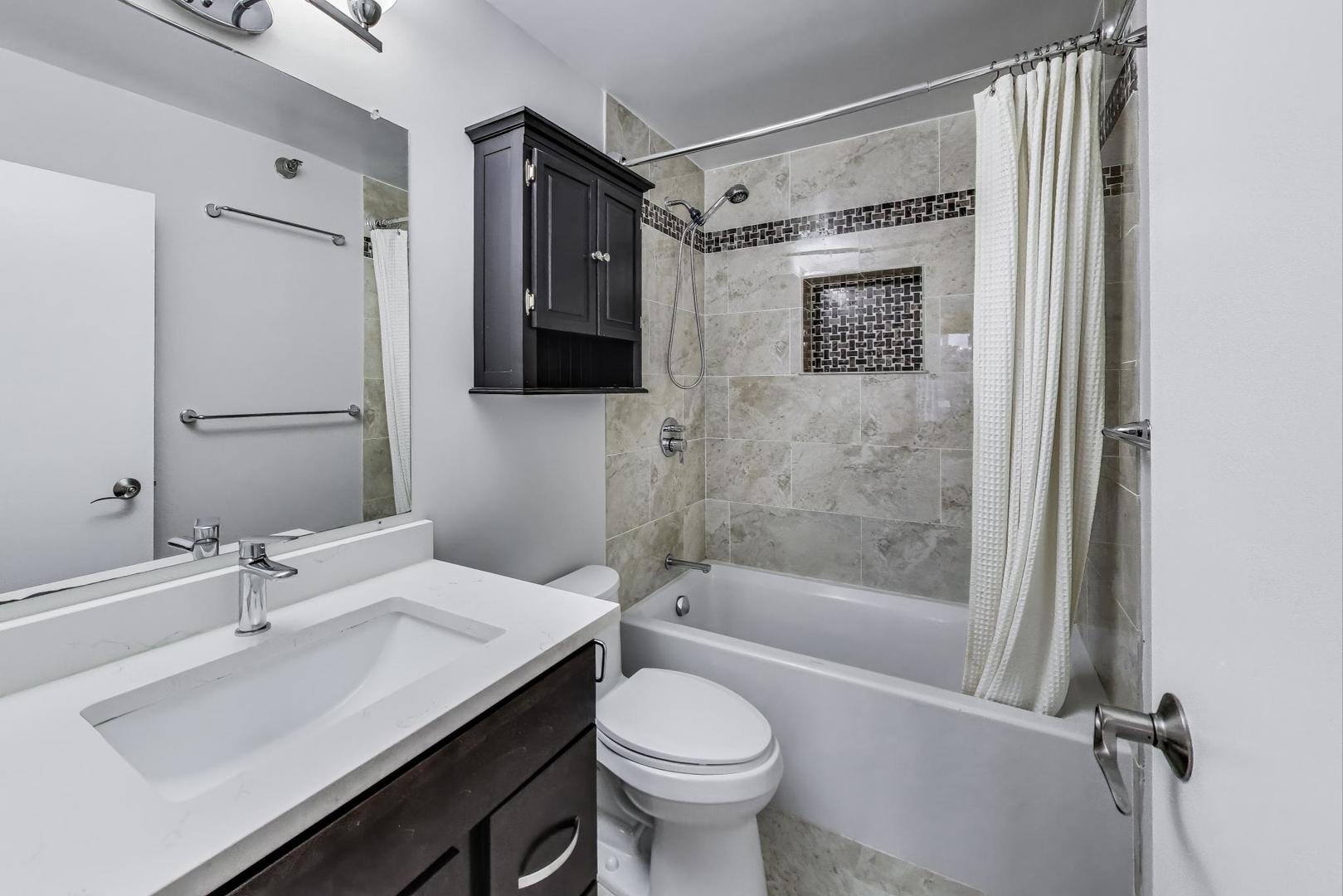 440 North Wabash Avenue, Unit 1605 Chicago, IL 60611 - Photo 27 of 53 a bathroom with a sink toilet and shower