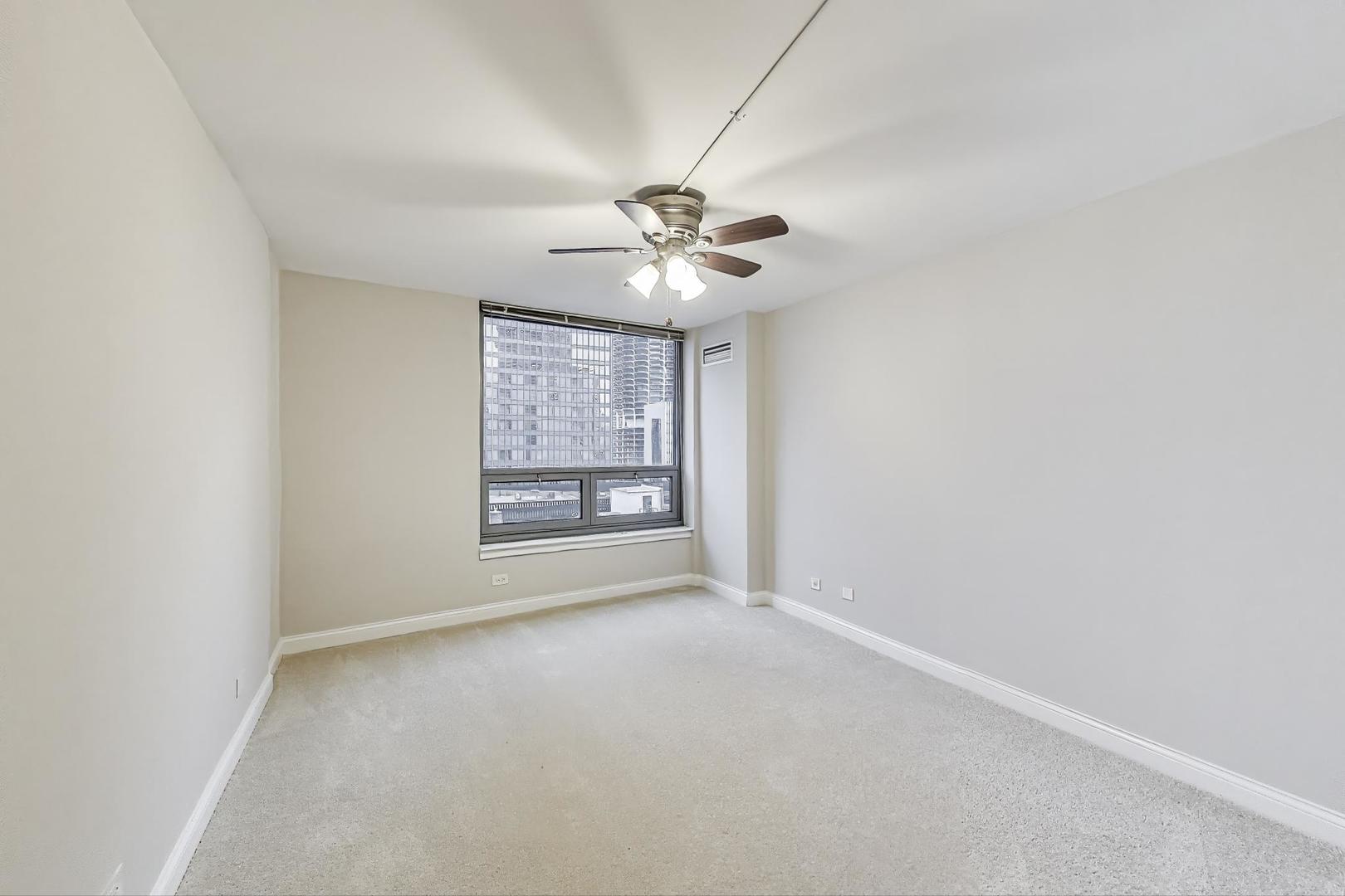 440 North Wabash Avenue, Unit 1605 Chicago, IL 60611 - Photo 29 of 53 an empty room with windows and fan
