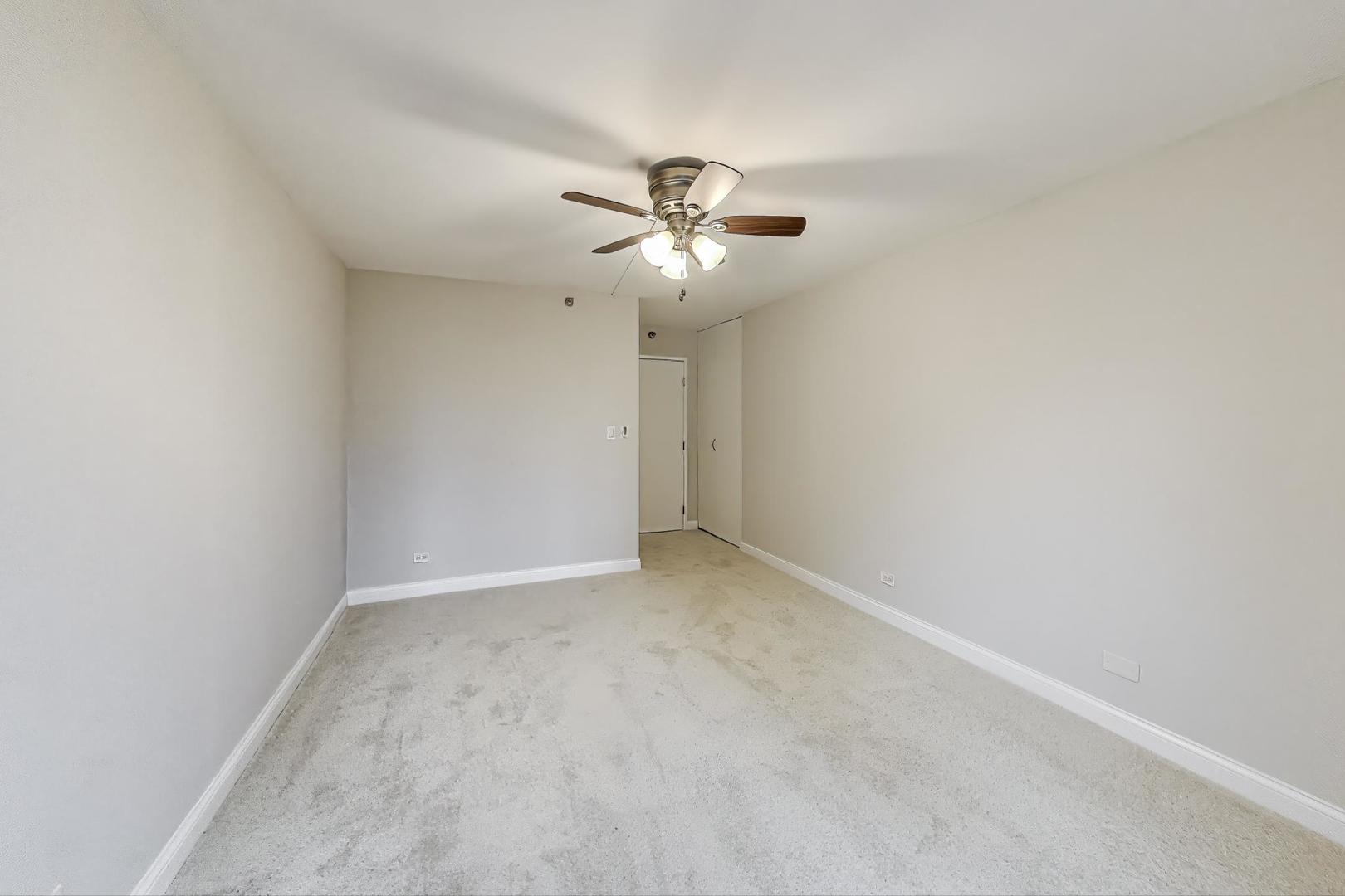 440 North Wabash Avenue, Unit 1605 Chicago, IL 60611 - Photo 30 of 53 an empty room with a chandelier fan and windows