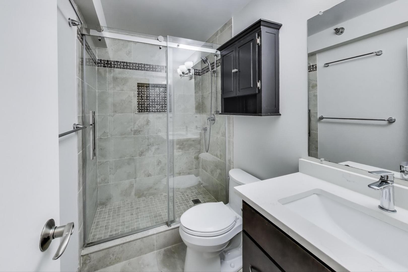 440 North Wabash Avenue, Unit 1605 Chicago, IL 60611 - Photo 31 of 53 a bathroom with a sink toilet and shower