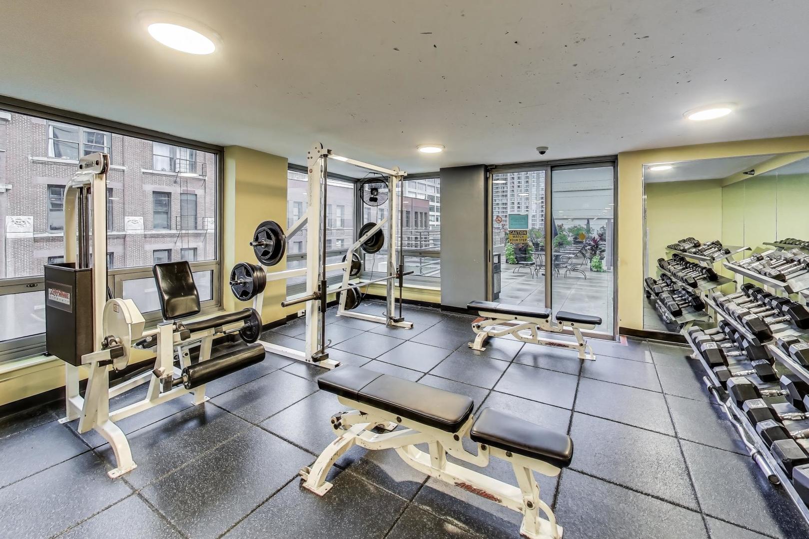 440 North Wabash Avenue, Unit 1605 Chicago, IL 60611 - Photo 36 of 53 a living room with furniture gym equipment and a large window
