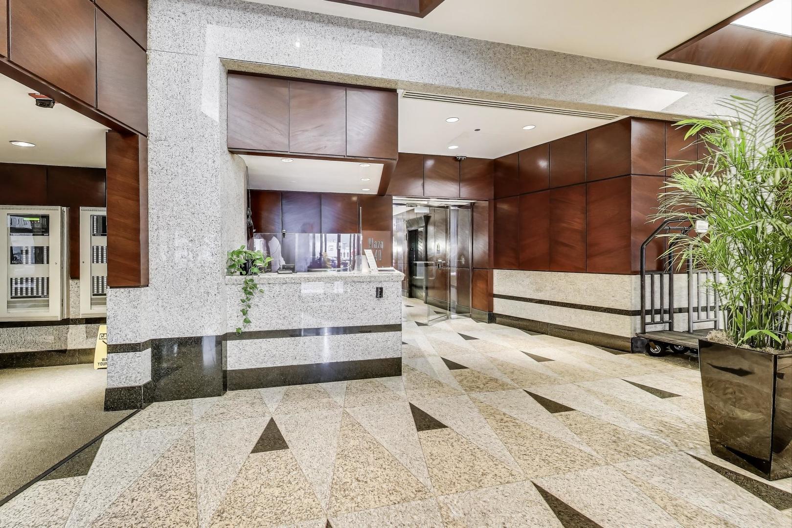 440 North Wabash Avenue, Unit 1605 Chicago, IL 60611 - Photo 8 of 53 a living room with stainless steel appliances kitchen island granite countertop furniture and a fireplace