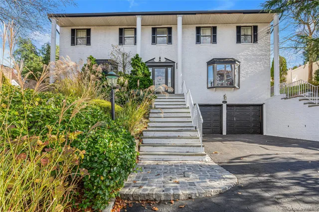 a front view of a house with a garden