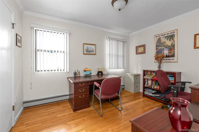 a view of a workspace with furniture and a window