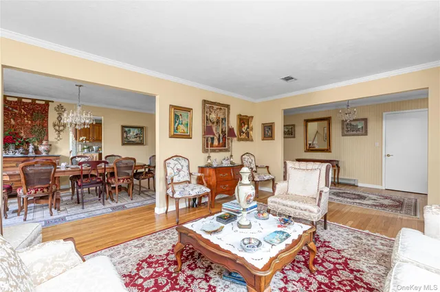a living room with furniture a rug and a dining table