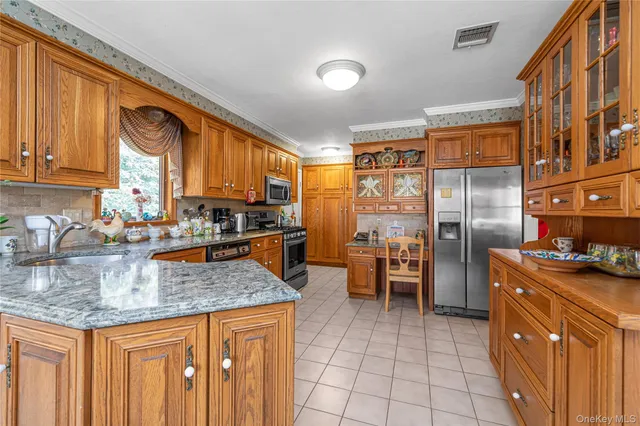 a kitchen with stainless steel appliances granite countertop a stove top oven a sink dishwasher and cabinets with wooden floor