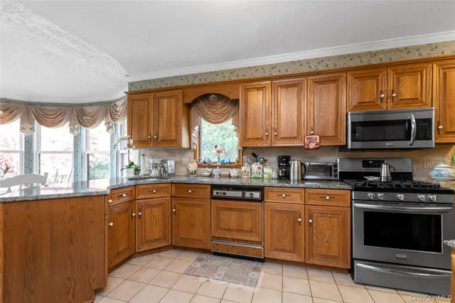 a kitchen with a sink stove top oven and microwave