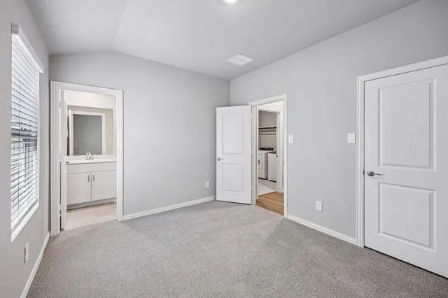 a view of empty room with closet and entryway