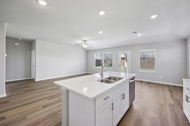 a kitchen with sink and cabinets