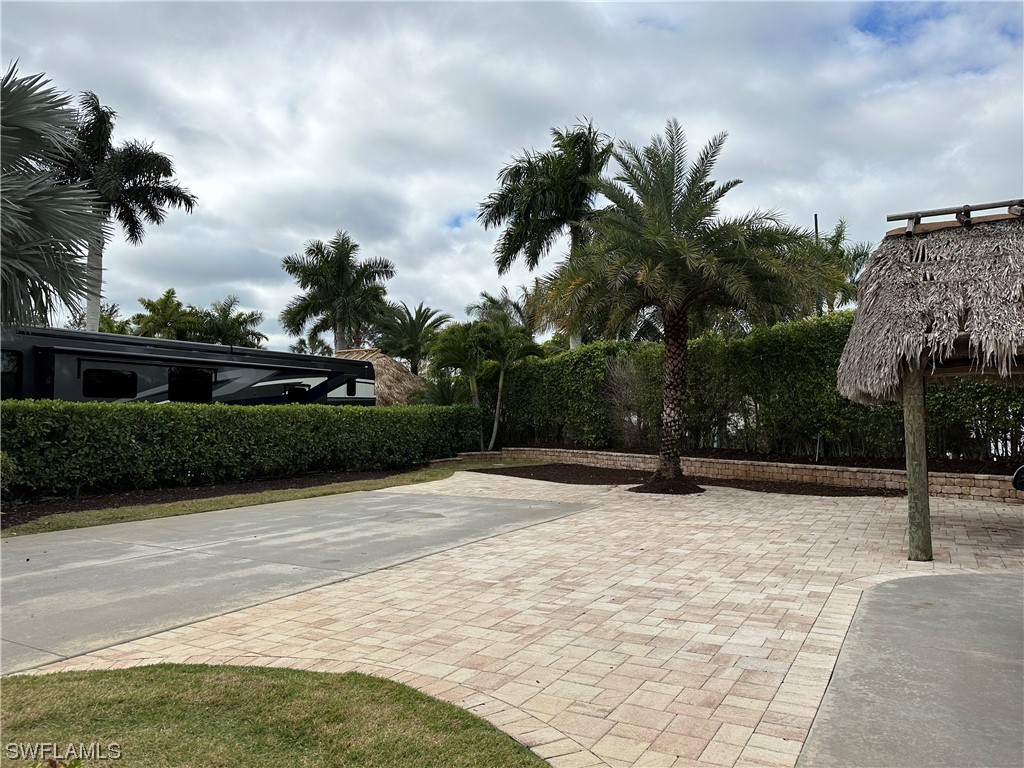 13530 Snook Circle Naples, FL 34114 - Photo 11 of 20 a backyard of a house with lots of green space and palm trees