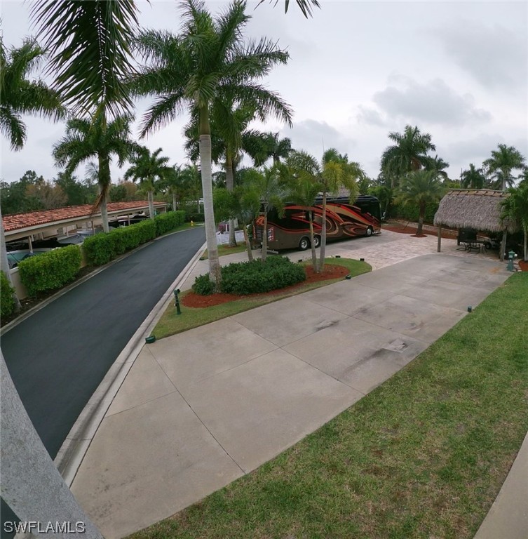 13530 Snook Circle Naples, FL 34114 - Photo 14 of 20 a swimming pool with barbeque oven outdoor seating and green space
