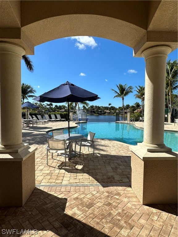 13530 Snook Circle Naples, FL 34114 - Photo 16 of 20 a view of a patio with table and chairs under an umbrella