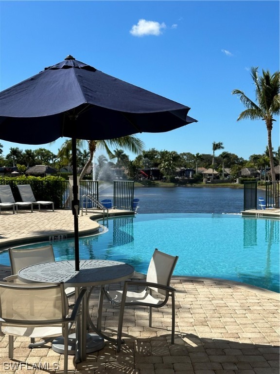 13530 Snook Circle Naples, FL 34114 - Photo 17 of 20 a view of a chairs and table under an umbrella in patio