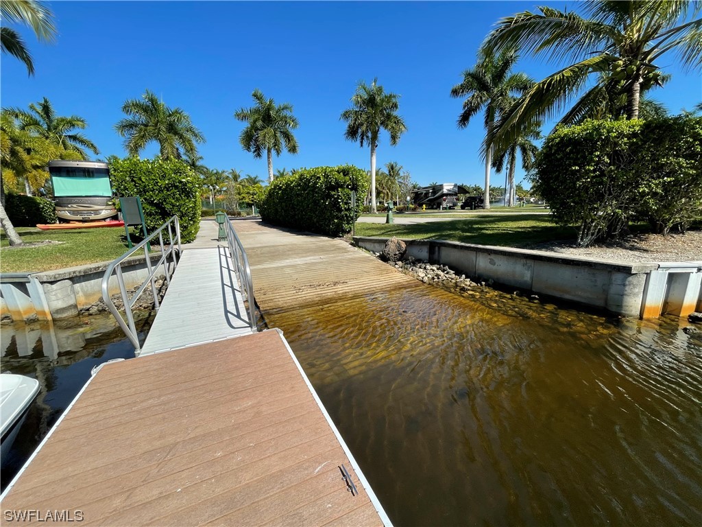 13530 Snook Circle Naples, FL 34114 - Photo 19 of 20 a view of swimming pool with a table and chairs