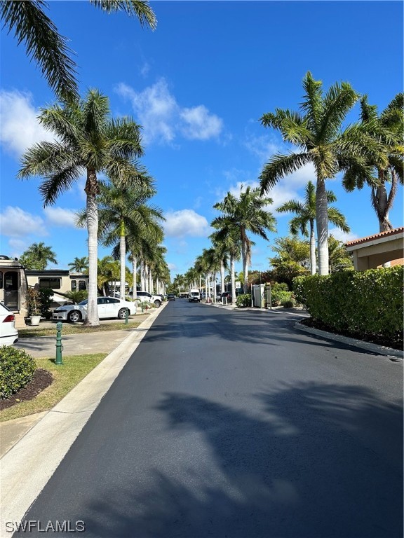 13530 Snook Circle Naples, FL 34114 - Photo 20 of 20 a view of a swimming pool with a lawn chairs under palm tree